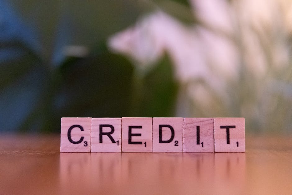 Close-up of wooden blocks spelling 'credit' with a blurred leafy background. A person looking at a credit score chart, showing an upward trend, symbolizing credit improvement.