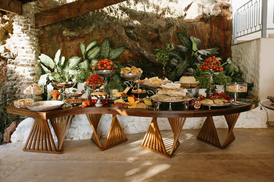 A lavish buffet table with assorted foods and vibrant greenery background. A piggy bank with coins and a retirement savings chart in the background, symbolizing long-term financial planning.